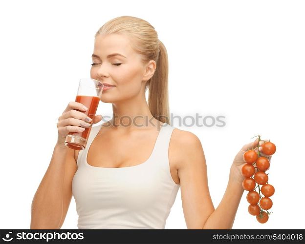 woman drinking tomato juice and holding bunch of tomatoes