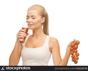 woman drinking tomato juice and holding bunch of tomatoes