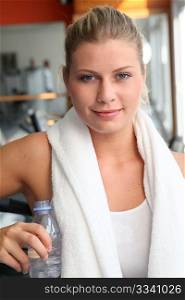 Woman drinking water after exercising