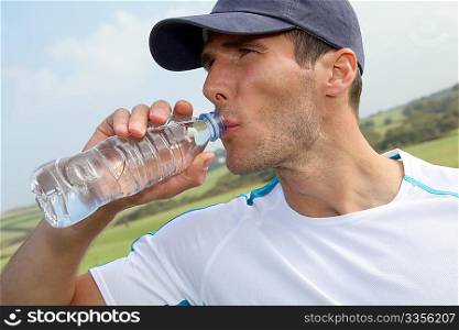 Woman drinking water after exercising