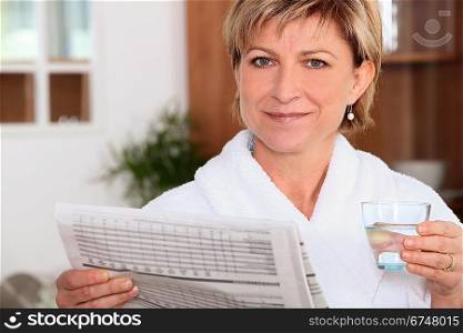 Woman drinking water and reading