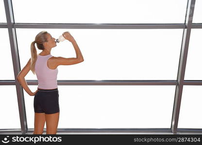 Woman Drinking Water at the Gym