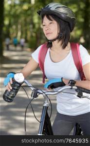 woman drinking water biking