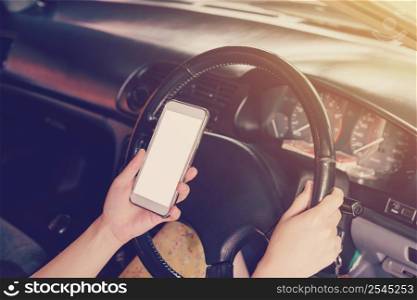 woman driver hands holding steering wheel driving and holding phone in a car