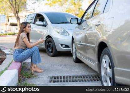 Woman drivers call insurance after a car accident before taking pictures and sending insurance. Online car accident insurance claim idea after submitting photos and evidence to an insurance company.