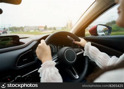 Woman driving car. girl feeling happy to drive holding steering wheel and looking on road
