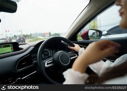 Woman driving car. girl feeling happy to drive holding steering wheel and looking on road 