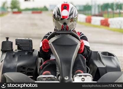 Woman driving go-cart on a sports track