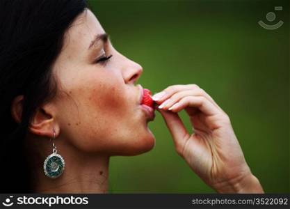 woman eat strawberry close up portrait