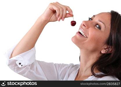Woman eating a cherry