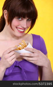 Woman eating a cone of chips