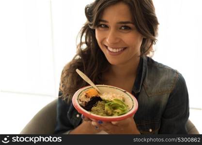 Woman eating a healthy bowl of superfoods