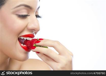 Woman eating a strawberry