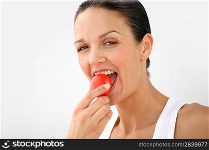 Woman eating a tomato