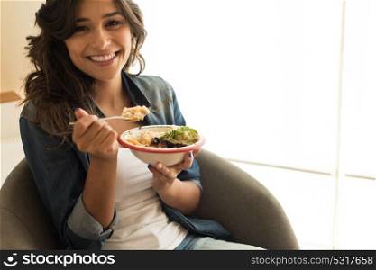 Woman eating a vegan bowl of superfoods