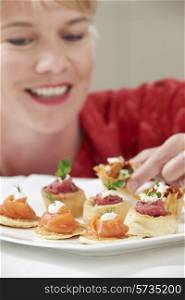 Woman Eating Appetizers On Plate
