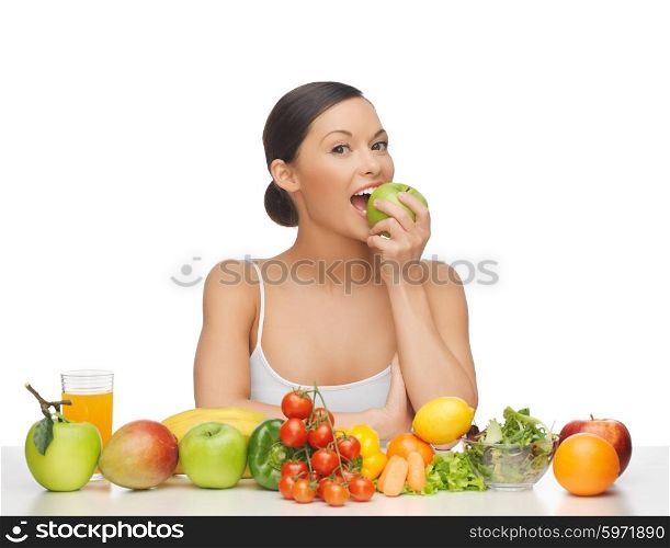 woman eating apple with lot of fruits and vegetables. woman with fruits and vegetables