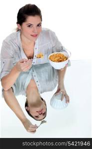 Woman eating bowl of cereal