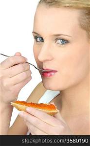 Woman eating bread and jam