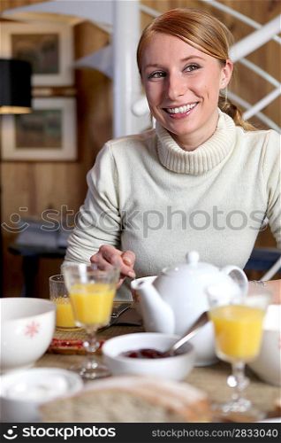 Woman eating breakfast at table