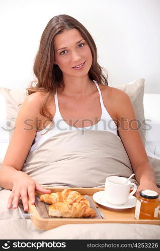 Woman eating breakfast in bed