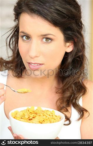 Woman eating cereal for breakfast