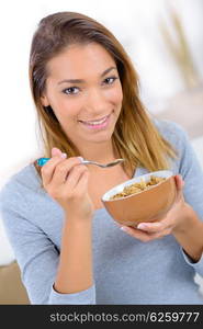 Woman eating cereal for breakfast