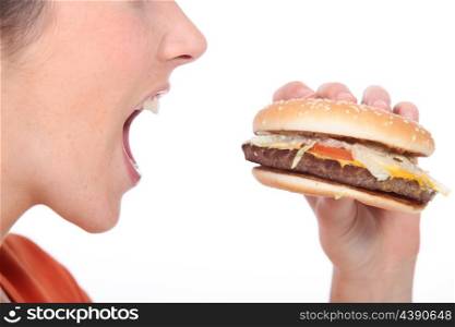 Woman eating cheeseburger