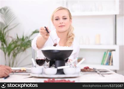 Woman eating fondue