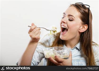 Woman eating fresh vegetable salad.. Woman eating fresh vegetable salad. Happy and joyful girl enjoying healthy food. Nutrition.