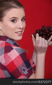 Woman eating grapes