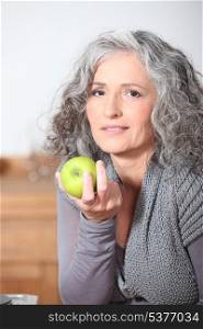 Woman eating green apple