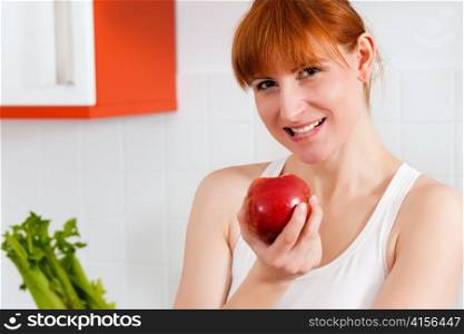 Woman eating healthy probably in her diet, having an apple in her hand