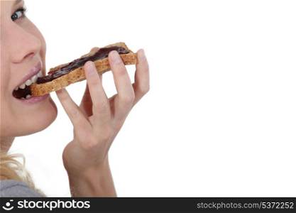 Woman eating jam on toast