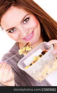 Woman eating oatmeal with nuts and dried fruits for breakfast. Girl holds plastic container take homemade lunch with healthy eating. Dieting nutrition concept. Woman eat oatmeal with dry fruits. Dieting