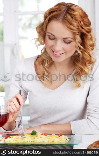 Woman eating pasta for dinner
