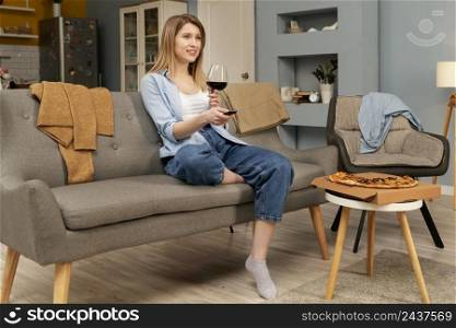 woman eating pizza while watching tv