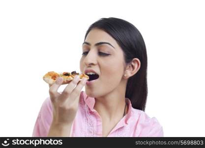 Woman eating slice of pizza