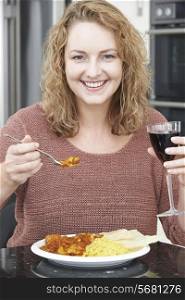 Woman Eating Takeaway Curry And Drinking Wine