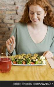 woman eating vegetarian food medium shot