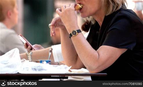Woman eats lunch in a terminal foodcourt