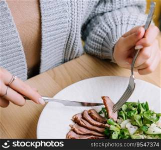 Woman eats Vitello Tonnato in restaurant