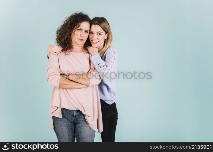 woman embracing displeased mother