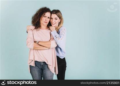 woman embracing displeased mother