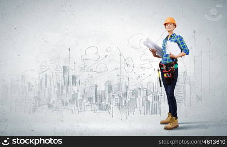 Woman engineer. Attractive smiling woman engineer wearing helmet and tool belt