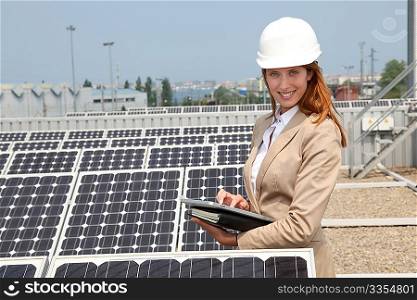 Woman engineer checking solar panels setup