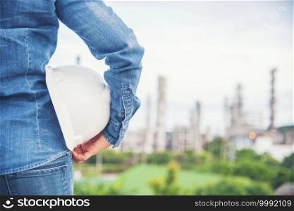 Woman engineer entrepreneur construction industry worker. Female engineer working refinery oil plant manufacturing. Young civil engineering construction wear hard hat safety helmet construction site.