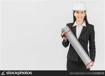 woman engineer helmet holding tube