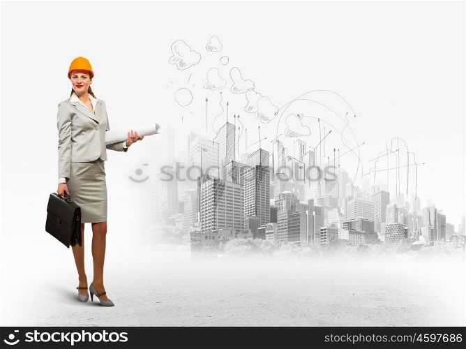 Woman engineer. Image of woman engineer in helmet with drafts. Construction concept