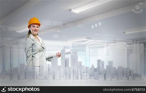 Woman engineer. Young woman in hardhat examining construction project